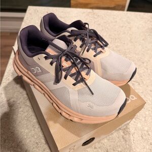 On Running White and Peach Athletic Shoes